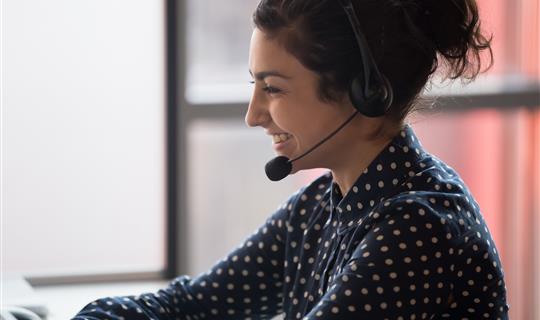 Smiling woman answering sale calls